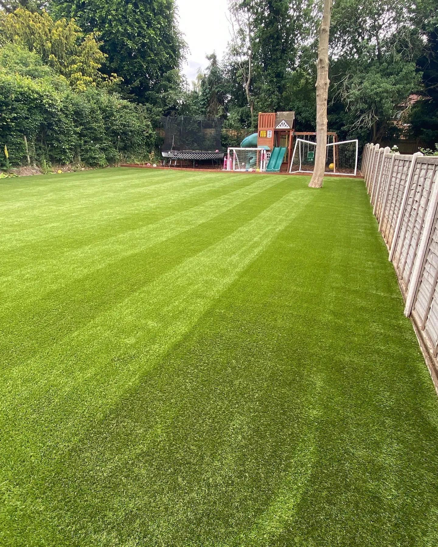 A striped artificial lawn with goals at the far end